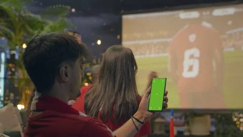 Isolated screen smartphone held by supporter to bet on soccer match Stock Photos