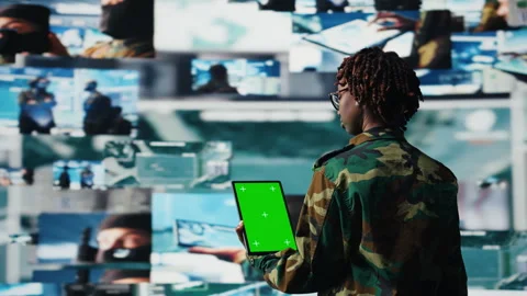 Isolated screen tablet app used by soldier in war room to operate CCTV gear Stock Footage 318856139