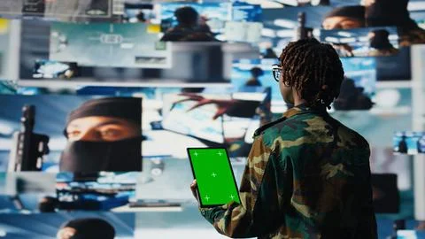 Isolated screen tablet app used by soldier in war room to operate CCTV gear Stock Photos