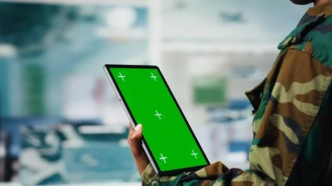 Isolated screen tablet app used by soldier in war room to operate CCTV gear Stock Photos