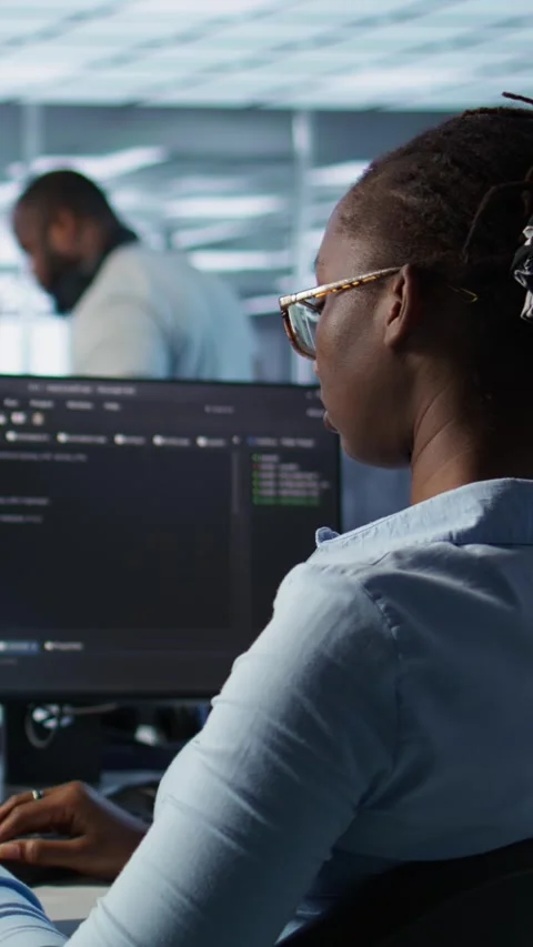 Isolated screen tablet in front of IT support workers coding on computers Stock Footage 319532640