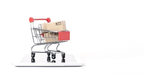 Isolated of Shipping paper boxes inside Red shopping cart trolley on tablet Stock Photos