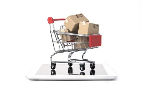 Isolated of Shipping paper boxes inside Red shopping cart trolley on tablet Stock Photos