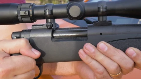 Isolated Shot of a Man Ejecting a Shell Casing from a Sniper Rifle Stock Footage 124981370