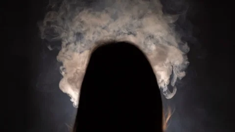 Isolated slow motion silhouetted closeup of a person with long hair binge Stock-Footage 125667772