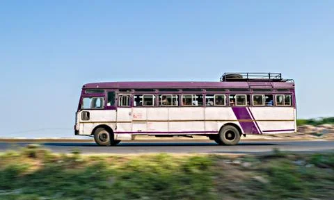 Isolated , slow shutter speed panning image of a speeding state transport bus Foto stock