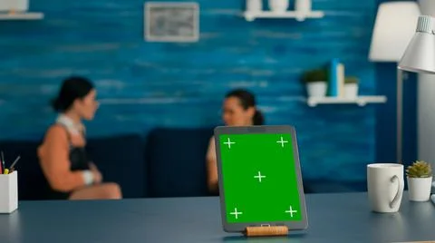 Isolated tablet computer with mock up green screen chroma key standing on desk Stock Photos