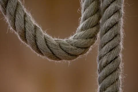 Isolated thick rope on a blurred background. Close-up photo. Stock Photos