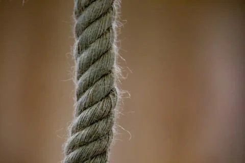 Isolated thick rope on a blurred background. Close-up photo. Stock Photos