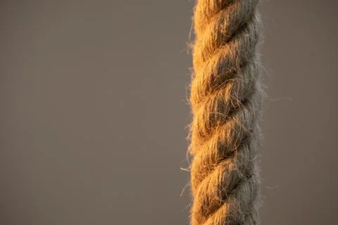 Isolated thick rope on a blurred background. Close-up photo. Stock Photos