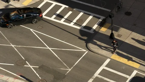 Isolated top-down view of a city cross walk with cars and unientifiable people. Video stock 127323240