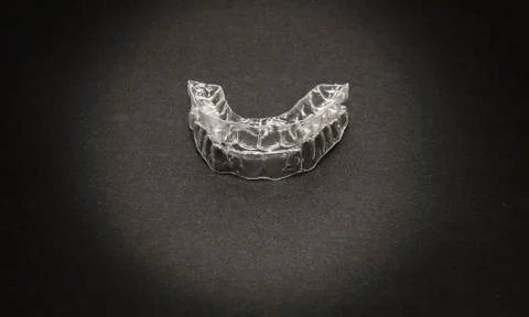 Isolated transparent teeth prosthesis over black for design Fotos Stock