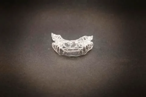 Isolated transparent teeth prosthesis over black for design Foto stock