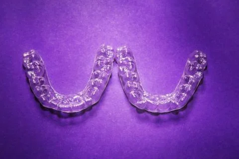 Isolated transparent teeth prosthesis over purple for design Stock-Fotos