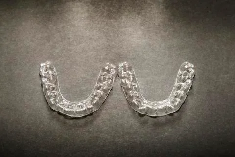 Isolated transparent teeth prosthesis over black for design Foto stock