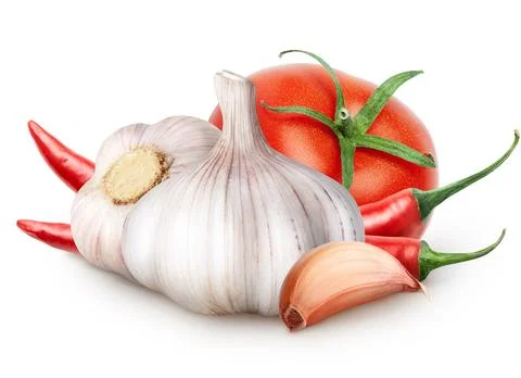 Isolated vegetables. Two garlic with segment, tomato, red hot chili peppers Stock Photos