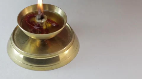 Isolated view of a burning brass lamp with a matchstick Stock Footage 292157757