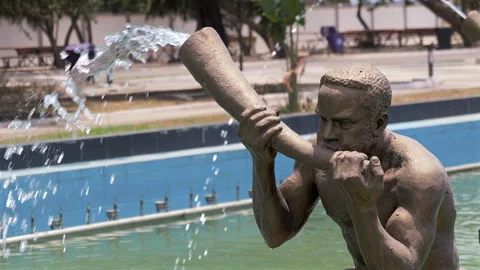 Isolated view of flute player water fountain sculpture, Accra, Ghana Stock-Footage 291155345