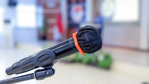 Isolated view of A Microphone in front of The Speaker Stock Photos