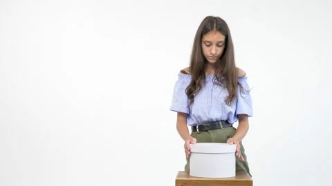 Isolated white background. girl opens a box with a gift and is disappointed Stock-Footage 137172012