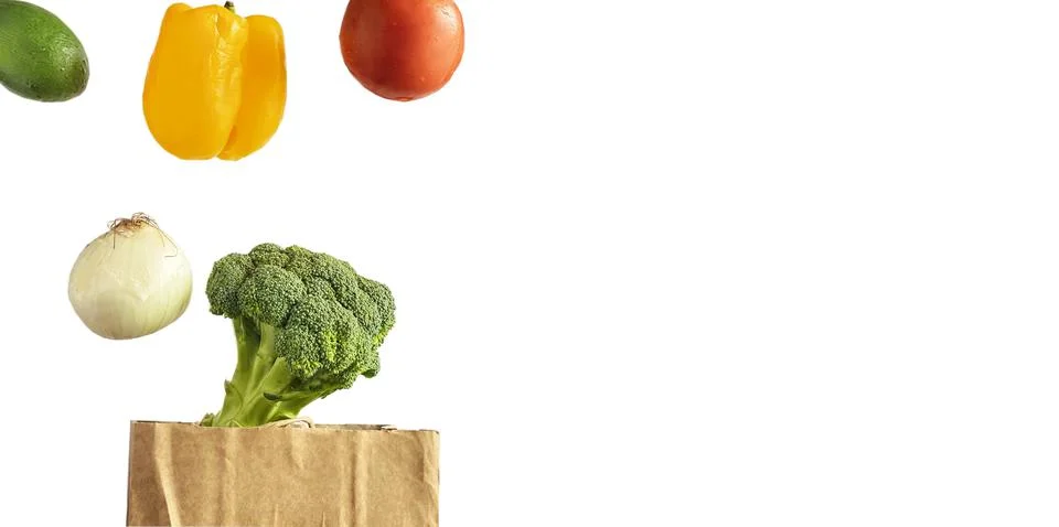Isolated on white background levitating vegetables tomato, pepper, avocado Stock Photos