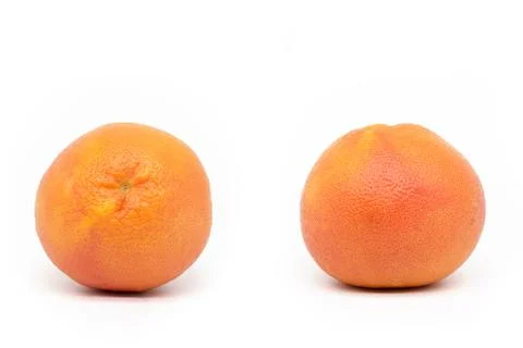 Isolated on a white background whole two-angle grapefruit. Stock Photos