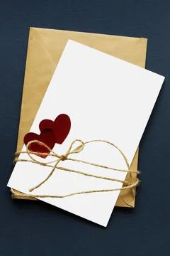 Isolated on white blank with two red hearts lies on a craft paper envelope th Stock Photos