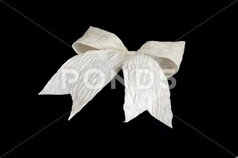 Isolated white bow for holiday gift box on black Stock Photos