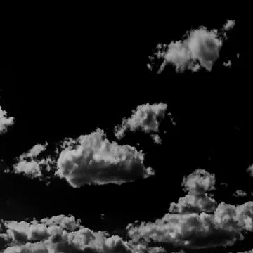 Isolated white clouds on black sky 写真素材