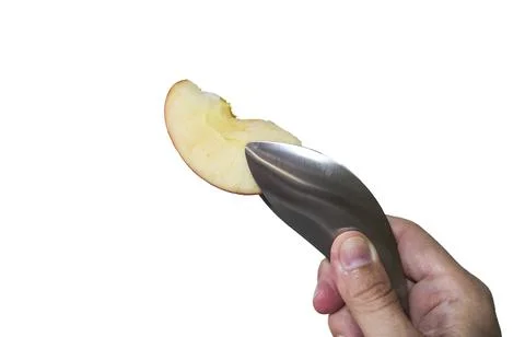Isolated on white of hand using clamp holding a slice of apple Stock Photos
