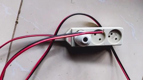 An isolated white power socket with three receptacles. Stock Photos