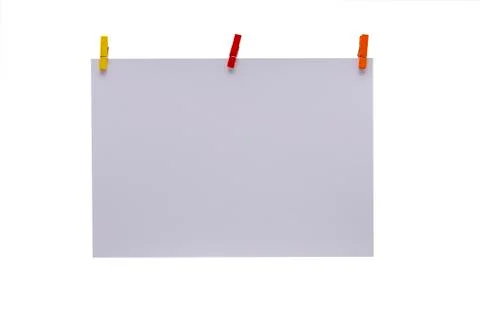 Isolated. White sheet and colored clothespins. Stock Photos