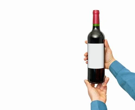 Isolated wine bottle with empty label mockup in female's hands. Stock Photos