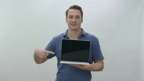 Isolated young man holding a tablet computer on white background. Stock Footage 196491084