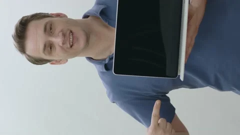 Isolated young man holding a tablet computer on white background. Stock Footage 201017531