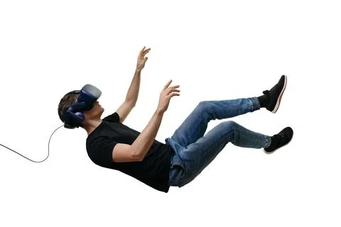 Isolated young men falling in zero gravity space while using virtual reality Stock Photos