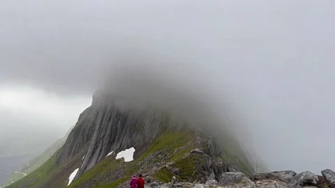 Isolation amid snow capped mountain peaks. Solitary explorer navigates through Stock Footage 327915889