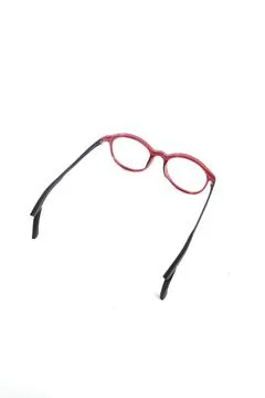 Isolation glasses on white background. Round eyeglass frames with red ear loc Stock Photos