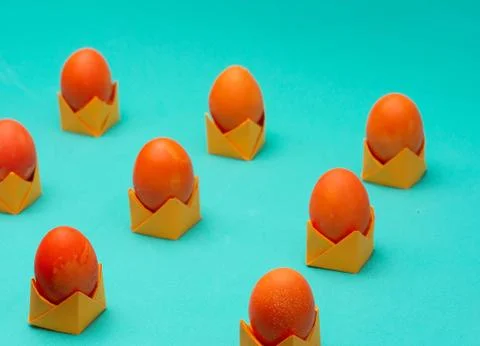 Isometric easter eggs layout. Orange colored eggs on origami stands. Easter c Stock Photos