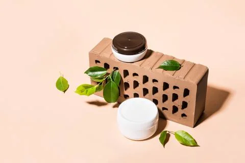 Isometric view of trendy composition made of brick and cosmetic products Stock Photos
