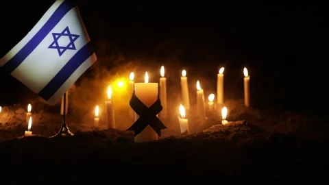 Israel flag on burning dark background with candle 스톡 동영상 252550107