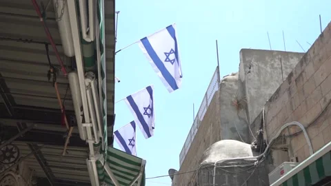 Israeli flags waving inside the old city of Jerusalem 스톡 동영상 138492909