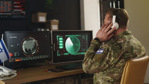 Israeli serviceman in headset tracking hostile activity via satellite systems Stock Footage 333307814