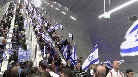 Israelis descending elevators at Yizhak Navon with flags Video stock 237083567