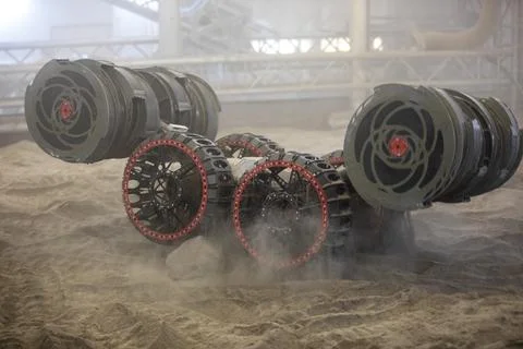 The ISRU Pilot Excavator digs in the regolith bin during testing inside Swa.. Stock Photos