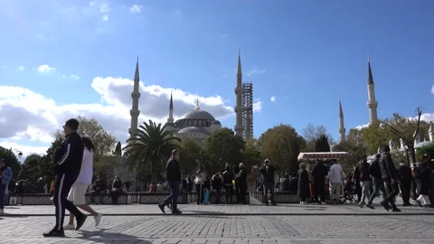 Istanbul Blue Mosque in Sultanahmet square, people walking resting on a bench. Stock Footage 164685889