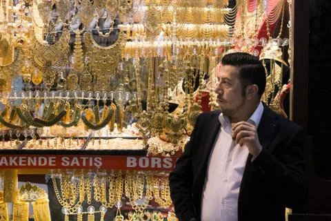 ISTANBUL, TURKEY: Jeweler in Gran Bazaar drinking tea in front of his shop.. Stock Photos