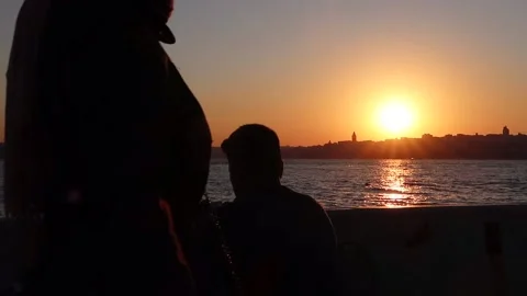 Istanbul - Uskudar at sunset time with young man drinking tea Stock Footage