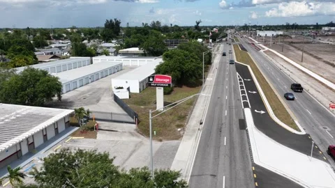 IStorage Self Storage facility sits beside busy divided highway, moving Stock Footage 339019876