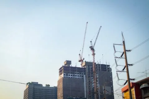 It about the tower crane installed on the building in the city with the ele.. Stock Photos